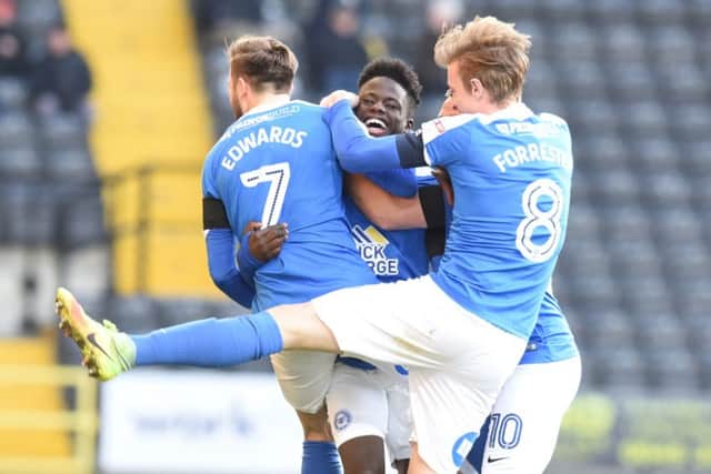 Leo Da Silva and his Posh team-mates celebrate his goal at Notts County. Photo: David Lowndes.