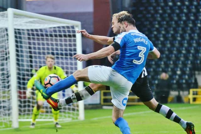 Posh full back Andrew Hughes is about to see his cross blocked by a Notts County hand. Photo: David Lowndes.