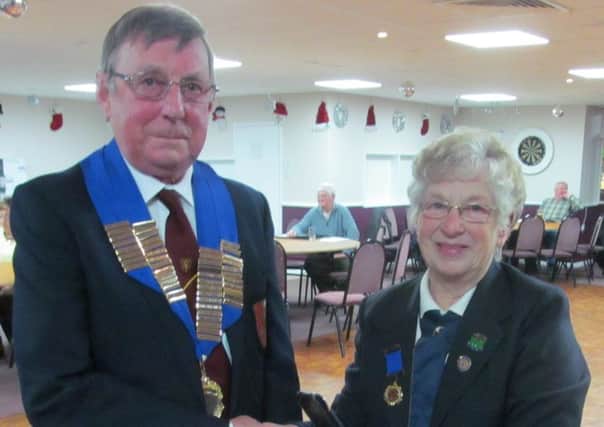 New Peterborough League president Bruce Saint (Yaxley) received the chain of office from outgoing president Jean Redhead (Whittlesey Town) at last weeks annual meeting.