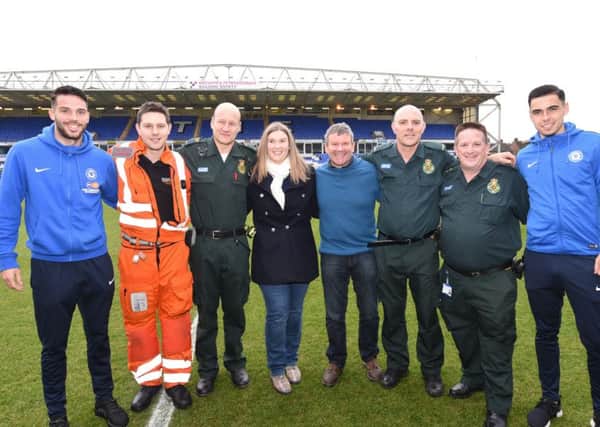 Magpas Air Ambulance paramedic Dan Phillips with East of England Ambulance Service paramedics Del Ferguson and Mark Chapman, ambulance manager Mark Parnell, Emily and Paul Starr and Posh players Andrew Hughes and Callum Chettle EMN-161112-185009009