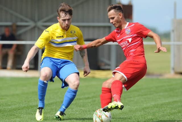Billy Smith (red) scored for Wisbech in their 3-0 win over Kirby Muxloe at the weekend.