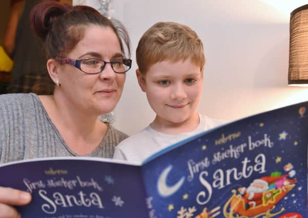 Samuel Montgomery (8) having Christmas at home in Dogsthorpe with his mum Kelly Montgomery now he is in remission from leukemia EMN-161213-091706009