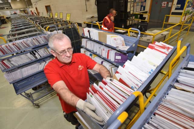 Busiest day of the year vat the letter sorting office at Post Office centre at Werrington.  Clive Williams sorting letters EMN-161213-160936009