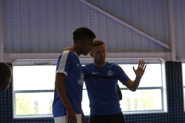 Posh Futsal coach Michael Johnson (right) issues instructions.