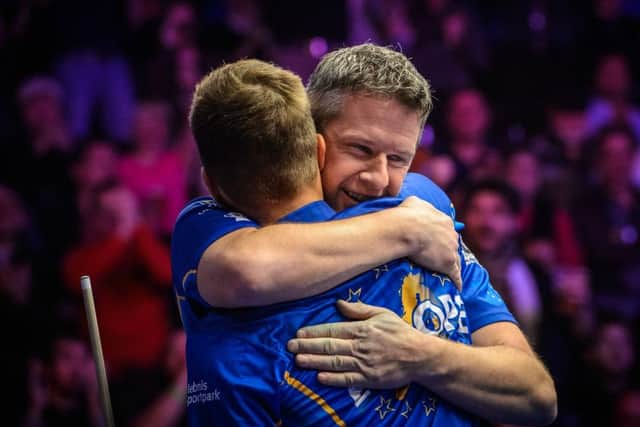 Mark Gray hugs his partner after a Mosconi Cup doubles victory.