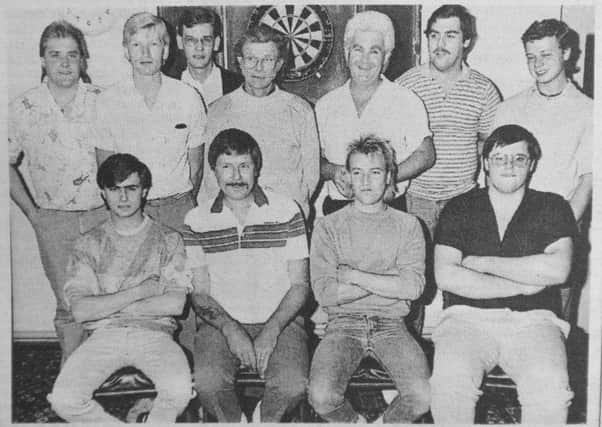 Pictured above is a darts team from 30 years ago.
It is the Peterborough second team that played in the Cambs  Super League.
The shot was taken before a 7-2 defeat against the Peterborough first team which included the likes of Dennis Harbour, Ken Summers and Peter Evison.
The players in the picture are Steve Porter, Graham Rootham, John Church, Mark Seeking, Dave Belson, Mick Woloschuk, Andy Wallace, Paul Smith, Kevin Bedford, Mick Rootham and Lionel Watkins.