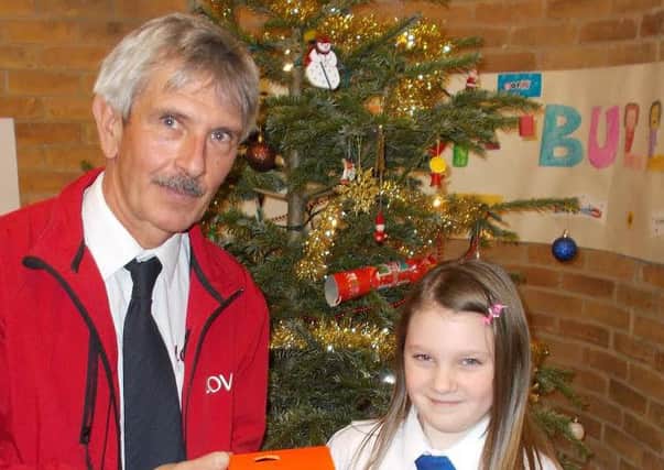 Trinity Holland is pictured  receiving her prize from Lovell senior site manager John Plested.