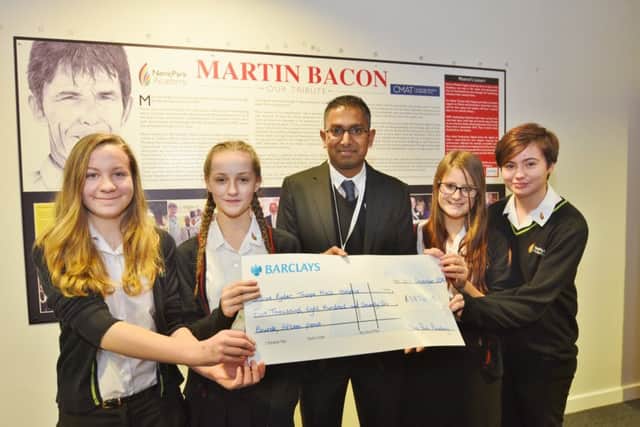 Martin Bacon plaque unveiled at Nene Park Academy. Sue Ryder@s Nelish Patel receives cheque from Daisy Doyle, Megan Swales, Ellie Coltman and Caitlin Brodie - the Bitter Sweets charity fundraisers. EMN-161217-180734009