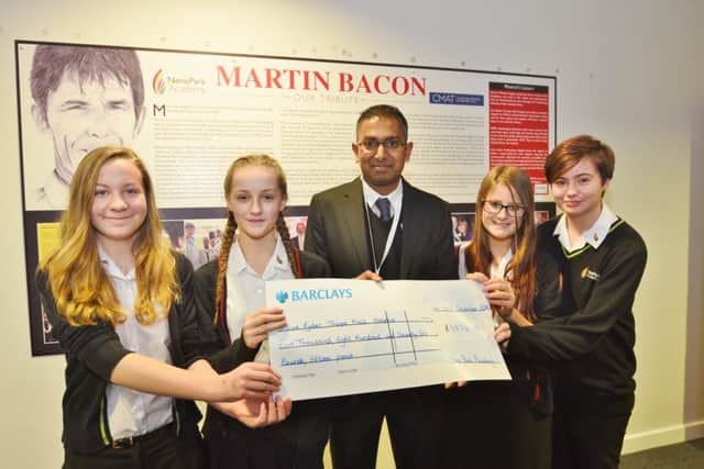 Martin Bacon plaque unveiled at Nene Park Academy.  Sue Ryder@s Nelish Patel receives cheque from Daisy Doyle, Megan Swales, Ellie Coltman and Caitlin Brodie -  the Bitter Sweets charity fundraisers. EMN-161217-180734009