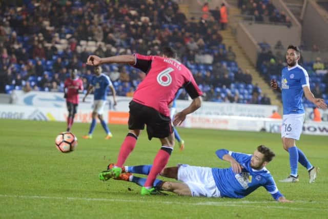 Posh midfielder Gwion Edwards slides into a tackle in the win over Notts County/ Photo: David Lowndes.