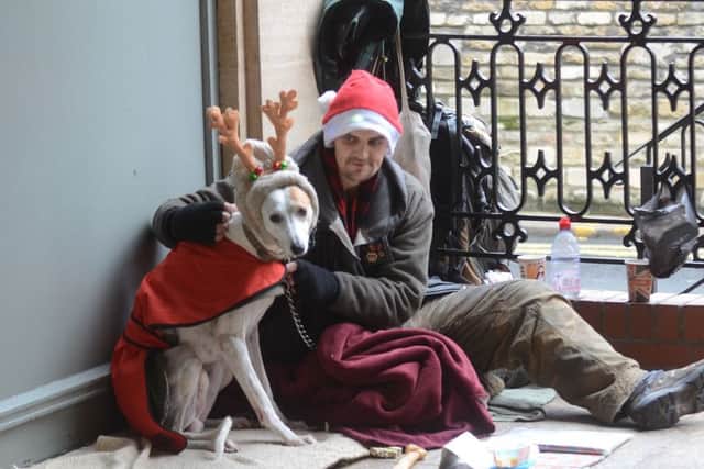 Big Issue seller Mick Holmes with his dog in St Peter's Arcade EMN-161219-182711009