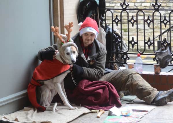 Big Issue seller Mick Holmes with his dog in St Peter's Arcade EMN-161219-182711009