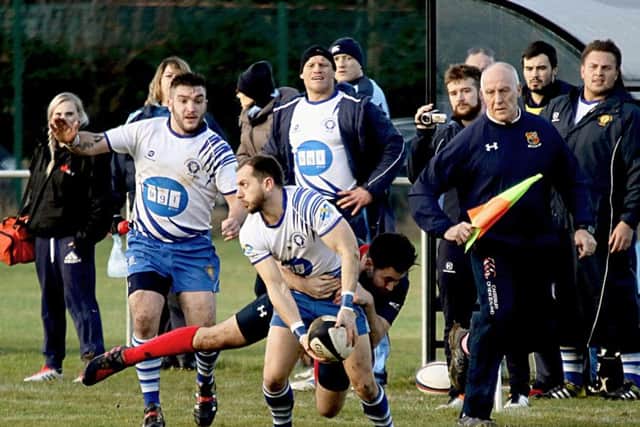 Lions scrum-half Tom Dougherty makes a pass against Lichfield. Picture: Mick Sutterby