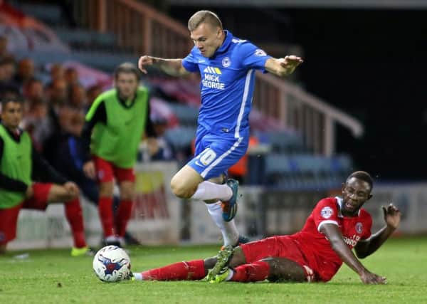 Harry Anderson of Peterborough United is tackled by El-Hajdi Ba of Charlton Athletic in a Capital One Cup match in August 2015.