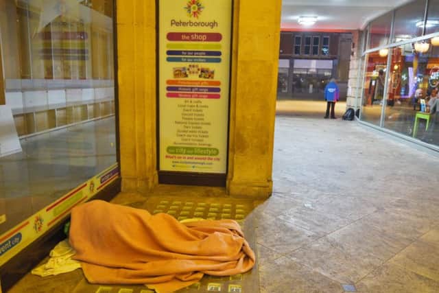 A rough sleeper in St Peter's Arcade with security guards in the background EMN-161223-105705009