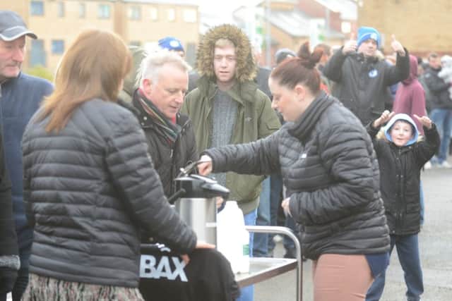 Posh staff provide hot drinks for queueing supporters. Photo: David Lowndes.