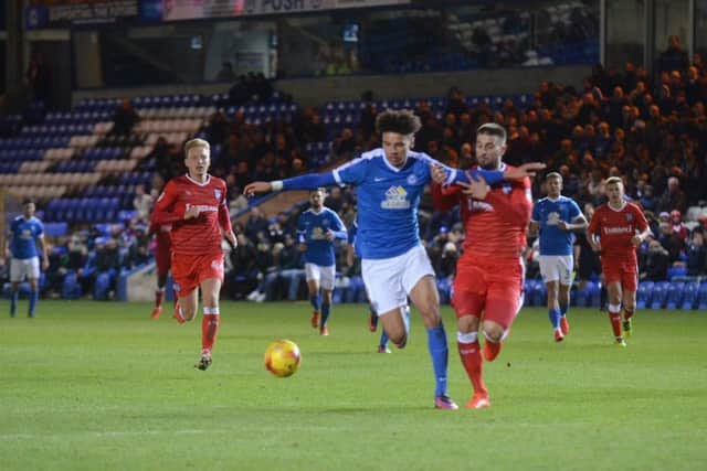 Posh striker Lee Angol is on his way to putting Posh in front against Gillingham. Photo: David Lowndes.