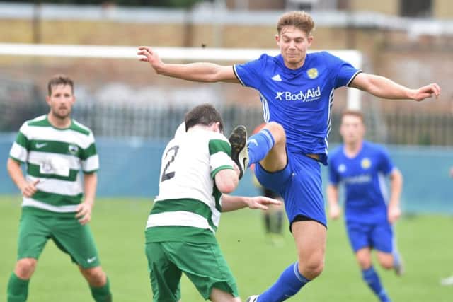 Peterborough Sports' striker Mark Jones in action against Newport Pagnell.