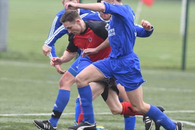 Netherton striker Tom Randall (centre, red) will be a key man in the Northants Junior Cup match against Corby Pegasus.