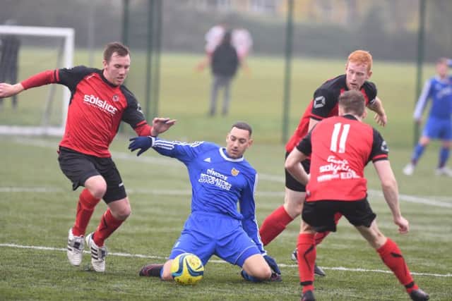 Action from a recent Netherton United (red) game against AFC Stanground Sports.