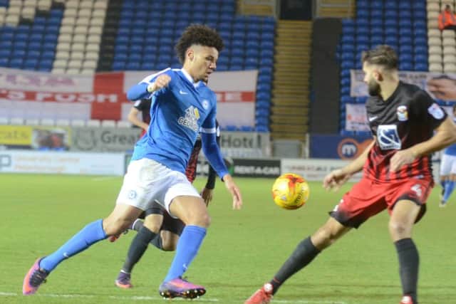 Posh striker Lee Angol takes on the Coventry defence. Photo: David Lowndes.