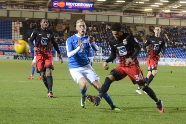 Posh star Marcus Maddison is stopped in tracks by Coventry defender Dion Kelly-Evans. Photo: David Lowndes.