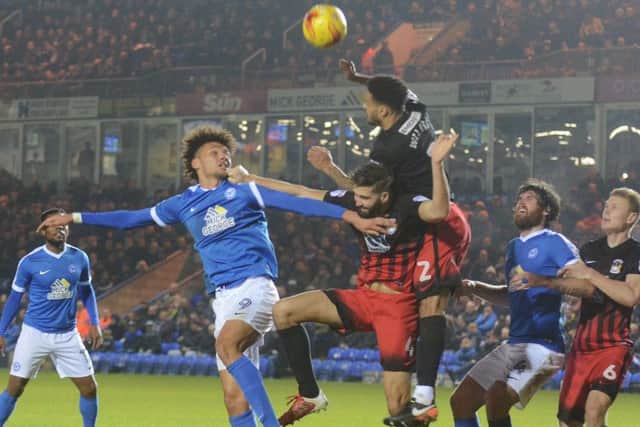 Posh striker Lee Angol challenges for a cross. Photo: David Lowndes.