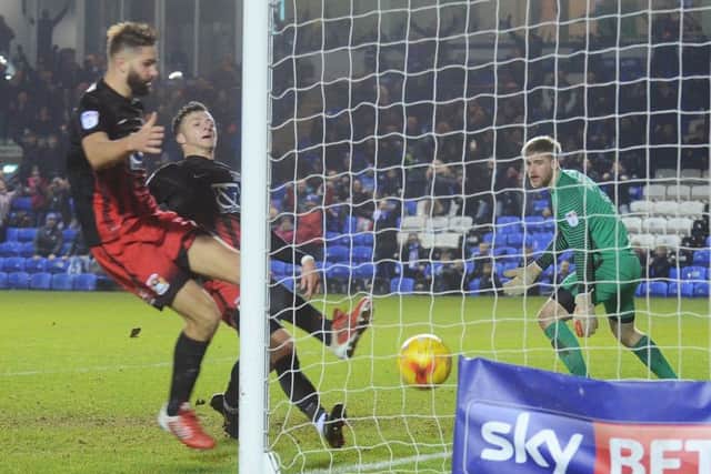 Michael Bostwick's header finds the corner of the bet to give Posh a draw against Coventry. Photo: David Lowndes.