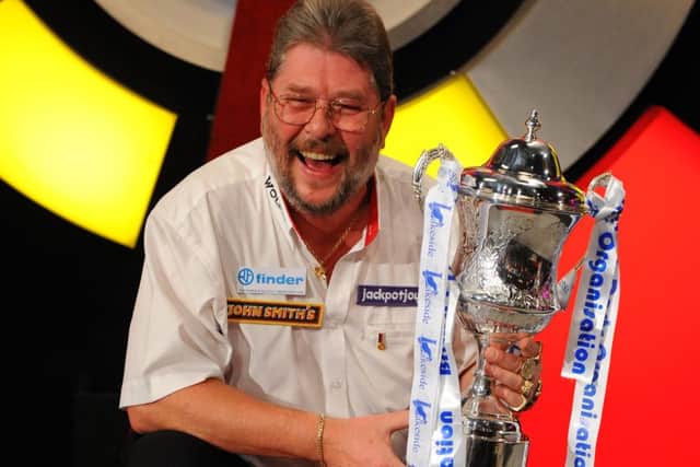 Martin Adams with the world championship trophy he last won in 2011.