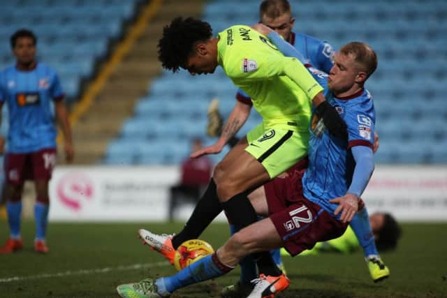 Posh substitute Lee Angol battles for the ball with Scunthorpe's Neal Bishop. Photo: Joe Dent/theposh.com.