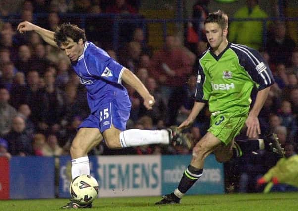 Gianfranco Zola is chased by Adam Drury.