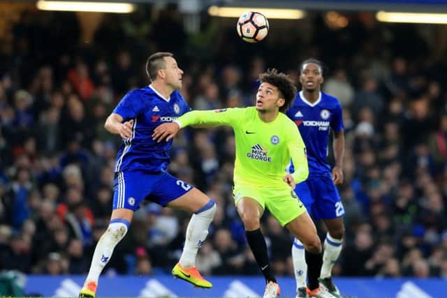 Chelsea's John Terry (left) and Peterborough United's Lee Angol battle for the ball. Picture: Adam Davy/PA Wire