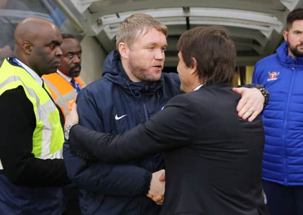 Posh manager Grant McCann meets Chelsea boss Antonio Conte before the game.