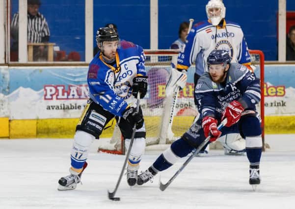 Captain James Ferrara protects the puck in the defensive zone against Sheffield. Picture: Tom Scott