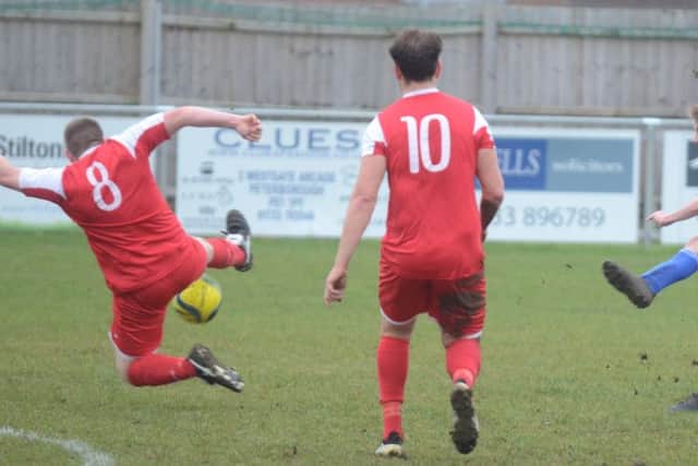 Peterborough Sports Reserves' Jack Keenan shoots at goal in the win over Wisbech Town Reserves (red). Photo: David Lowndes.
