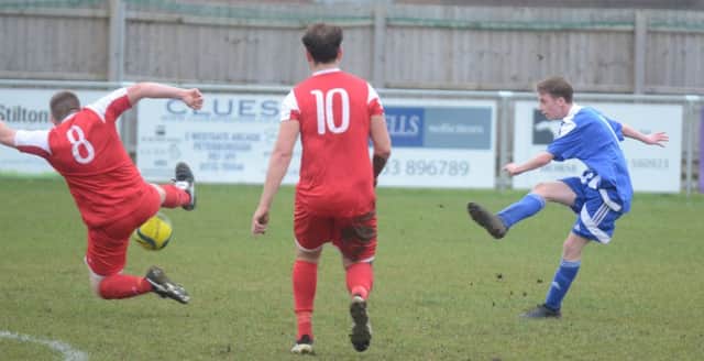 Peterborough Sports Reserves' Jack Keenan shoots at goal in the win over Wisbech Town Reserves (red). Photo: David Lowndes.