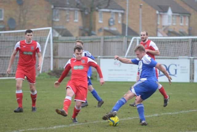 Goal-scorer Karl Gibbs (blue) in action for Peterborough Sports Reserves against Wisbech Town Reserves. Photo: David Lowndes.