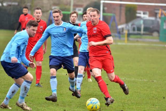 Action from Pinchbeck United's 1-0 Lincs Junior Cup defeat to Nettleham (blue). Photo: Tim Wilson.