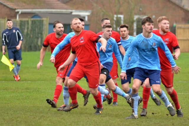 Pinchbeck United (red) press for a goal during their Lincs Junior Cup defeat to Nettleham. Photo: Tim Wilson.