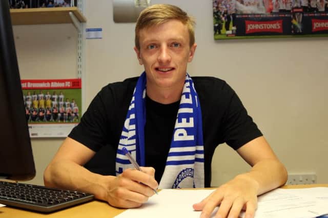 Chris Forrester signs for Posh in September, 2015. Photo: Joe Dent/theposh.com.