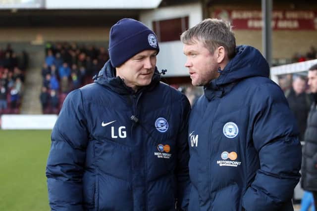 Posh boss Grant McCann (right) and his assistant Lee Glover have a plan in place for the January transfer window.