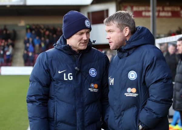 Posh boss Grant McCann (right) and his assistant Lee Glover have a plan in place for the January transfer window.