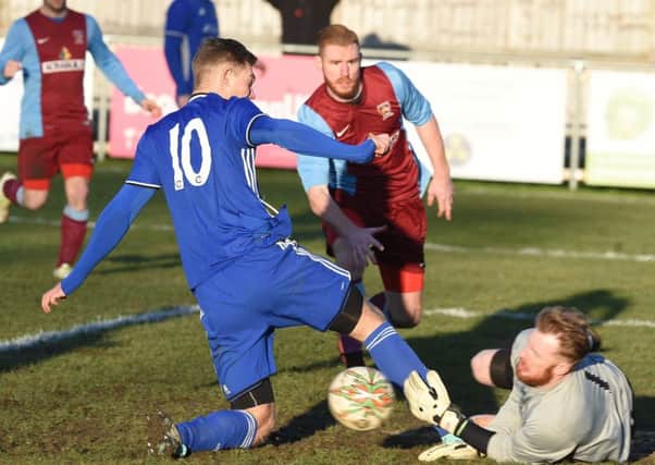Action from Peterborough Sports' 4-1 win over Deeping Rangers. Sports are in blue. Photo: David Lowndes.