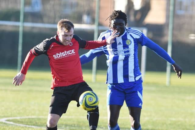 Netherton United's Ash Jackson fends off Ali Nyang of Peterborough Sports Reserves in their President's Shield quarter-final at the Grange. Photo: David Lowndes.