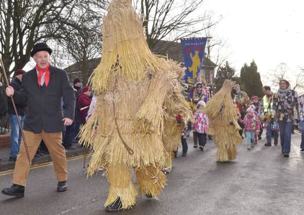 Straw Bear Festival 2017 at Whittlesey. Straw Bear and his keeper leading the parade EMN-170114-174520009