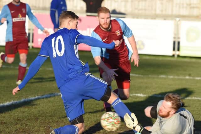 Deeping Rangers (claret) in action at Peterborough Sports. Photo: David Lowndes.