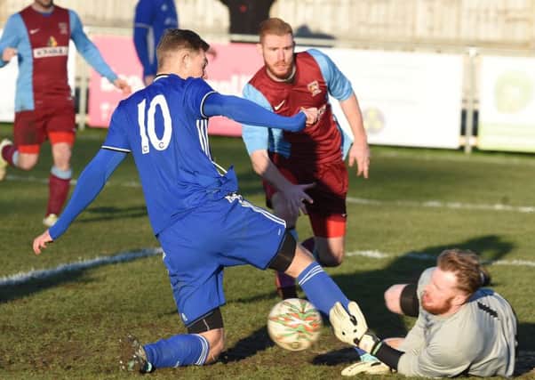 Deeping Rangers (claret) in action at Peterborough Sports. Photo: David Lowndes.