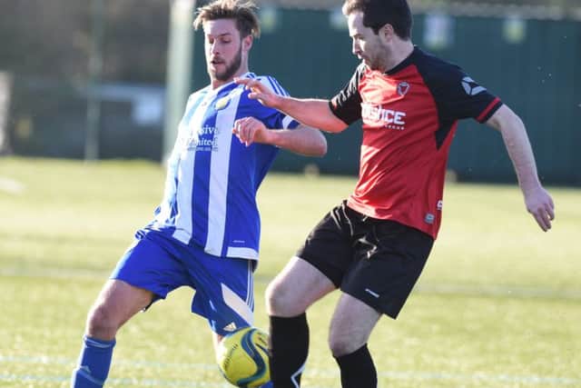 Netherton centre-back Ben Daly (red) in action during a weekend win over Peterborough Sports Reserves. Photo: David Lowndes.