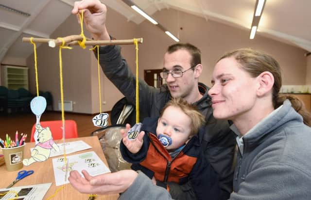 Winnie the Pooh day at Sacrewell Farm. Sarah-Jane Bancroft, a visitor experience assistant with  Graham Tecklenberg and his one-year-old son Lewis making a mobile. EMN-170115-154821009