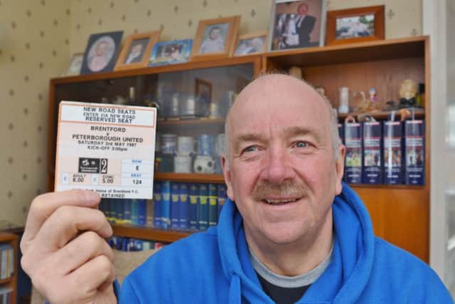 Mick Robinson, the Posh stato, who is to attend his 900th Posh game on Saturday. He is holding the ticket for the last game he missed on the 3rd May 1997 EMN-170117-181100009